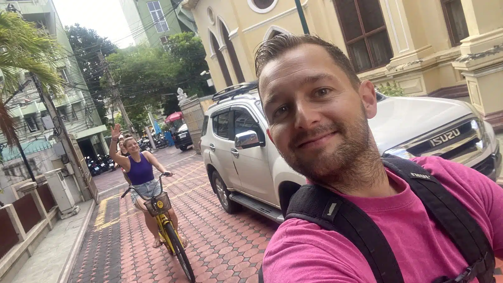 Selfie of Paul at the start of the Co van Kessel bike tour in Bangkok, with a yellow Co van Kessel bike behind him